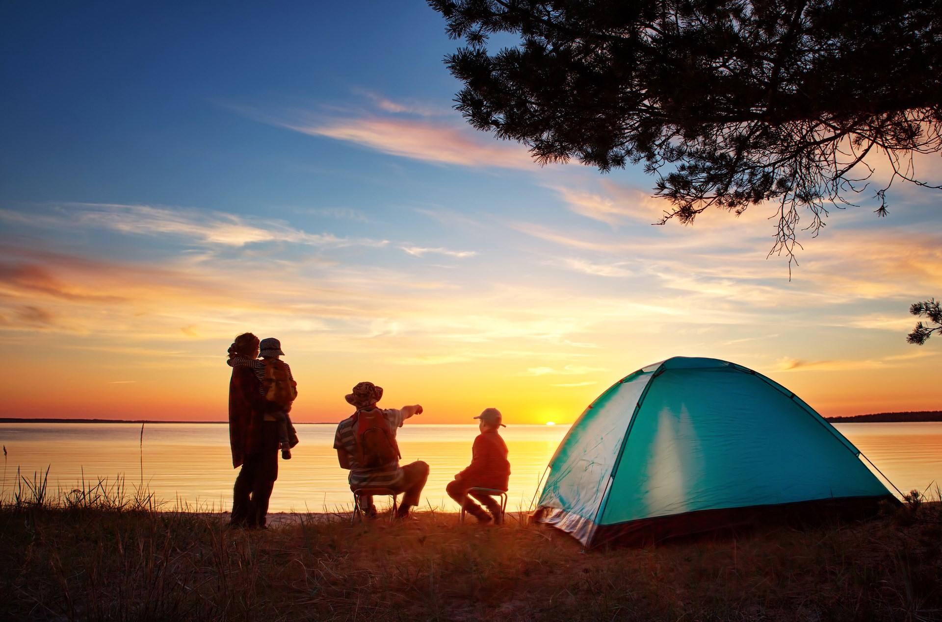 Family camping at sunset